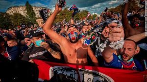 PSG fans chant near the Parc de Princes Stadium as they prepare to watch their team play.